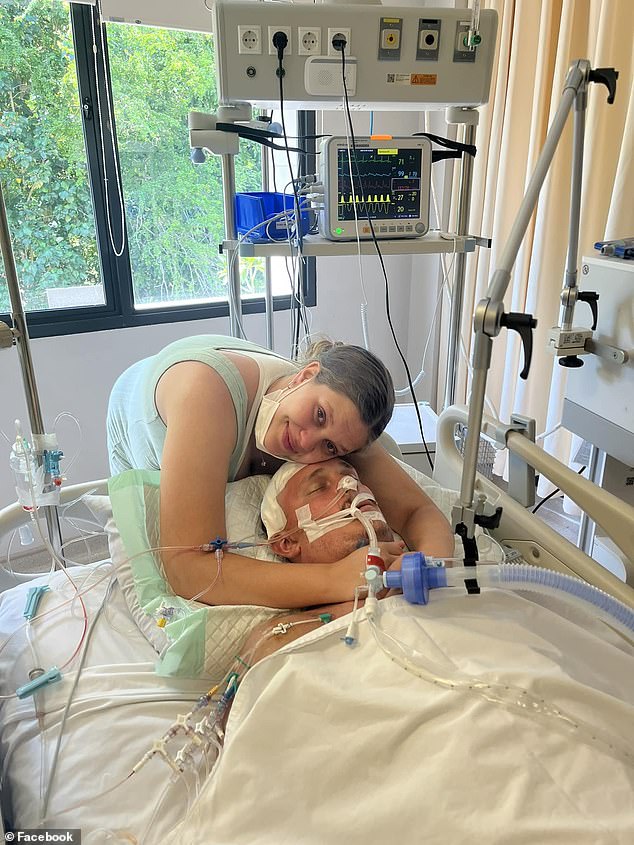 Leah Malligan (pictured with her arms around her husband Kevin) finally received good news about his condition on Sunday evening