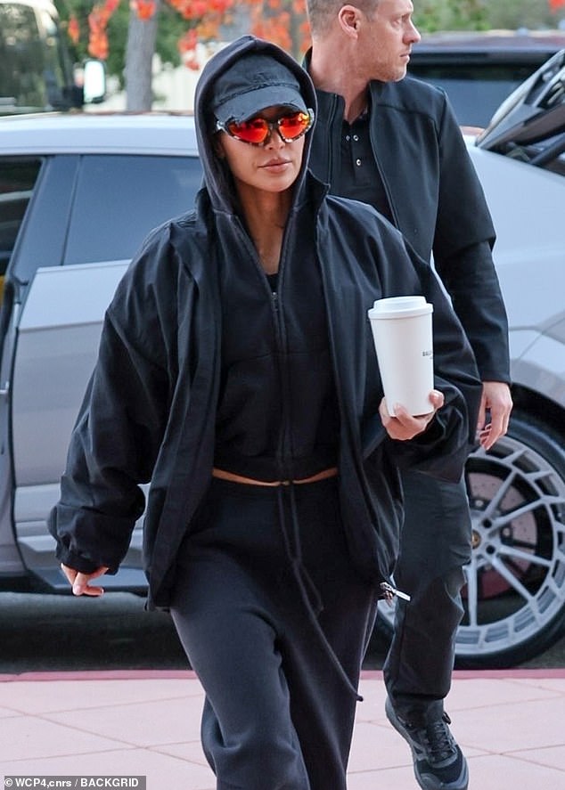 The reality TV personality, 43, looked relaxed in an all-black tracksuit with an oversized bomber jacket over it as she entered the building with her eight-year-old son