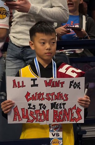 A young fan held up a sign saying he wanted to meet Lakers guard Austin Reaves for Christmas