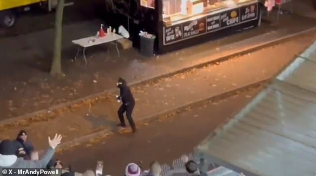 A hooligan from Legia Warsaw, wearing a balaclava, supplied himself with bottles of mayonnaise