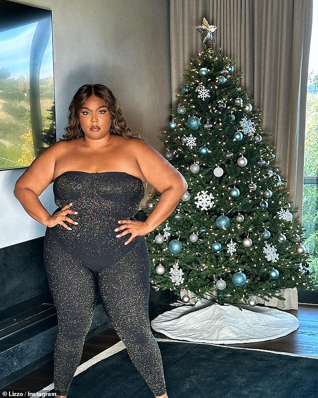 Lizzo, 35, posed in a sparkling bodysuit from her shapewear brand Yitty in front of a decorated Christmas tree