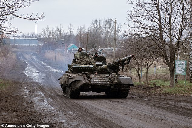 A T-64 tank drives past in Novoselivka Persha after leaving Avdiivka, Ukraine, on December 4