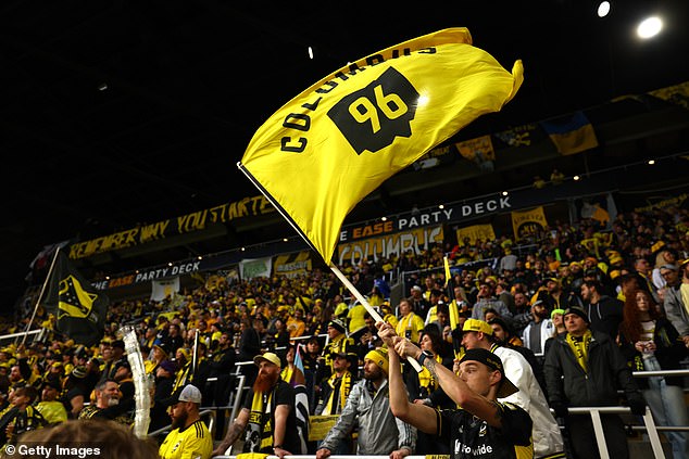 A fan waves the Columbus Crew flag before the start of the MLS Cup on Saturday