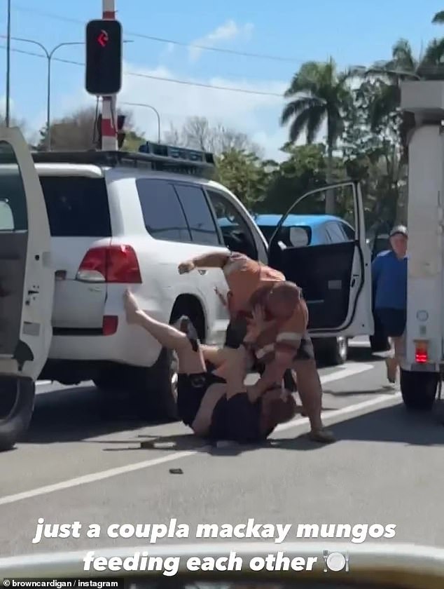 Two men (above) were spotted arguing in Mackay, north Queensland, over a road rage incident