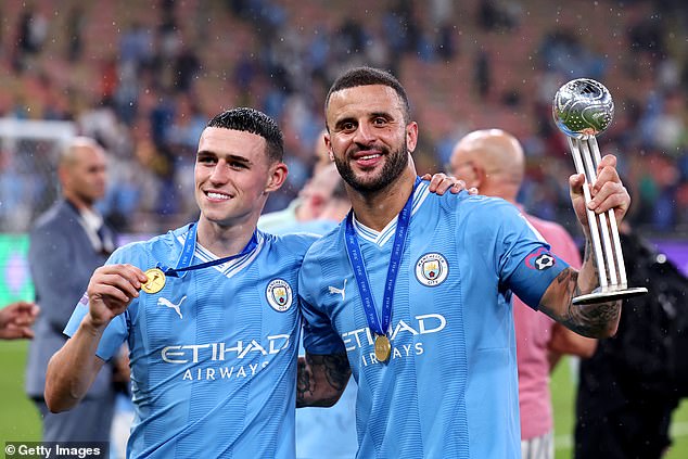 Walker and goalscorer Phil Foden celebrate with the trophy and medals in Saudi Arabia