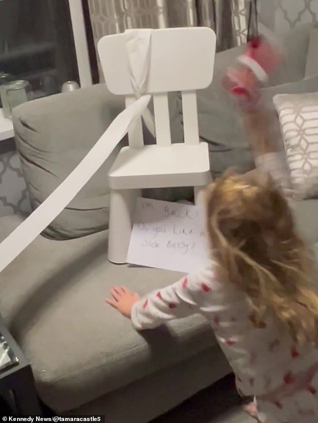 The funny video shows Betsy running into the living room in her pajamas – where she is suddenly confronted with the elf's mess