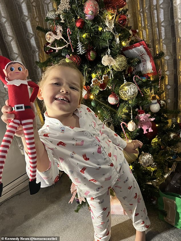 This is the hilarious moment a shocked four-year-old girl - Betsy (pictured) - beat a mischievous toy elf 'to death' after seeing toilet paper thrown across the living room