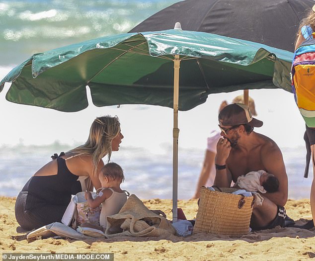 The couple were all smiles as they enjoyed the sun with their young family