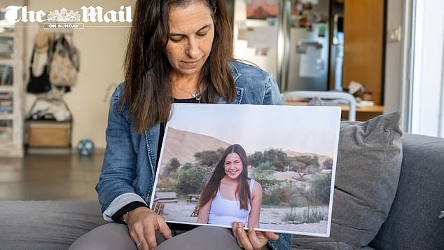 Dr.  Levy-Schacher (pictured holding a photo of her daughter Naama Levy) urged mothers around the world to 