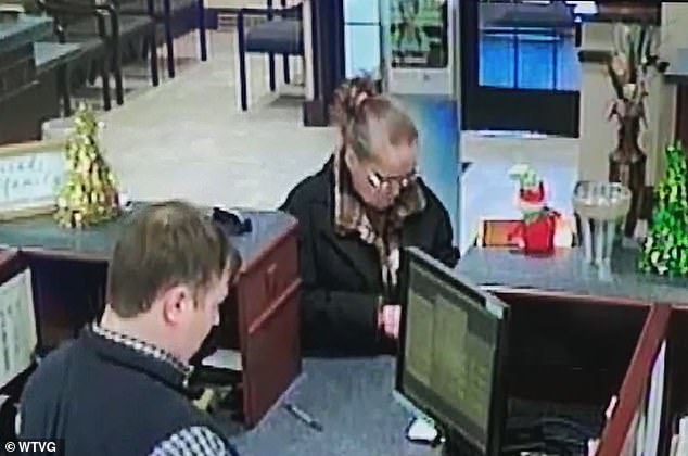 The suspect, pictured, bears a resemblance to a scammer who Oregon police say targeted at least five banks using a fake passport and stolen Social Security numbers.