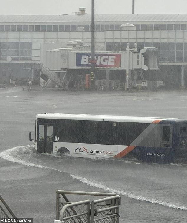 Flights were scuttled at Sydney Airport on Sunday night after 64mm of rain fell in just an hour and a half (pictured)