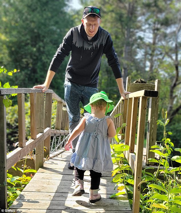 Markus Harwood-Jones, 32, is raising 21-month-old River with his 33-year-old husband, Andrew McAllister (pictured), and their 33-year-old co-parent, Hannah Dees