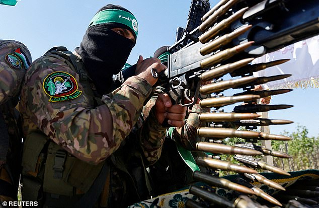 A Palestinian fighter from Hamas's armed wing takes part in a military parade marking the anniversary of the 2014 war with Israel