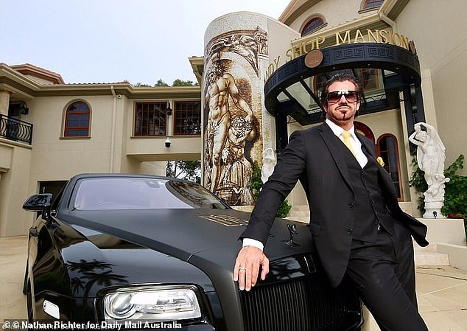 Tobacco magnate Travers 'Candyman' Beynon has put his extravagant 14-bedroom, 13-bathroom Gold Coast 'Candy Shop Mansion' on the market.  In the photo: Beynon at the front of his luxurious country house