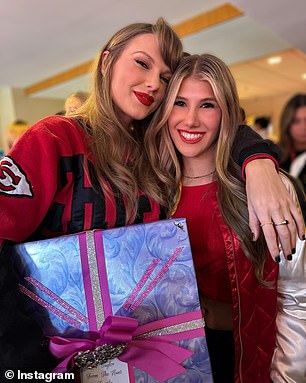 Ava Hunt poses for a photo with Taylor Swift and the gift her family gave the pop star