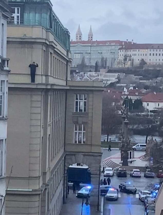 A lone student is seen calling for help while balancing on a ledge.  Then he tiptoes around the corner