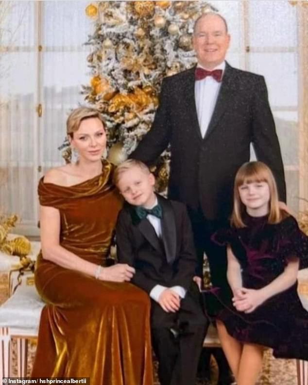 Prince Albert stands behind his smiling family in formal attire in a glamorous photo released for this year's annual Christmas card