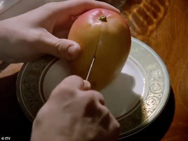 The scene shows the Belgian detective cutting a mango with a knife at a country house