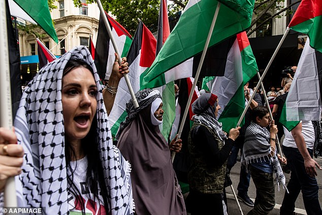 Pro-Palestinian supporters occupy the entire road in front of Flinders St Station as they urge unions to join growing calls for peace in the Middle East