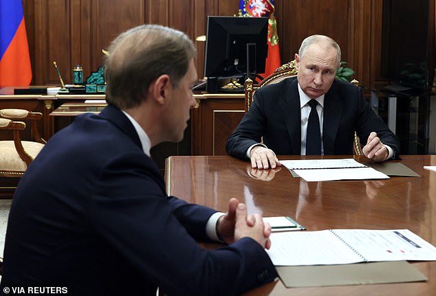 Putin listens to Deputy Prime Minister and Minister of Industry and Trade Denis Manturov during a meeting at the Kremlin in Moscow on October 24, 2023