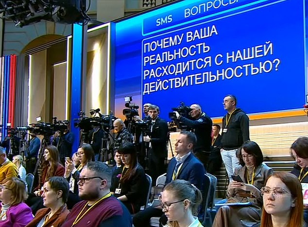 'Why is your 'reality' in conflict with our lived reality?'  this message, which was shown on the screens in the room, asked the Russian president during his annual press conference