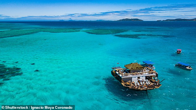 Castro took a group of friends to Fiji late last year where he celebrated the $2.04 billion win, including a stop at 'floating paradise' bar Cloud 9 (pictured)