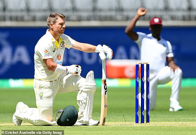 Aussie player David Warner takes a knee ahead of the first ball of the Test at Optus Stadium in Perth against West Indies