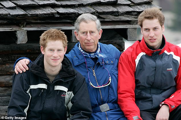 King Charles with his arms around Prince William and Prince Harry during the royal family's skiing holiday in Klosters, Switzerland on March 31, 2005