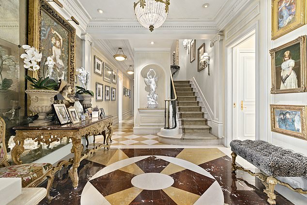 Upon entering the home, guests are greeted by a grand foyer with marble floors, Corinthian columns and ornate mirrors.