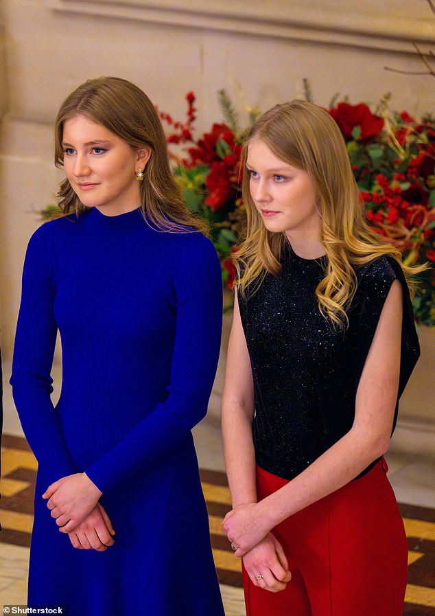 The young royal, 22, posed for photos with King Philippe, 63, Queen Mathilde, 50, Prince Emmanuel, 18, and Princess Eleonore, 15, as the family got into the festive spirit.  Pictured with her sister Eleonore