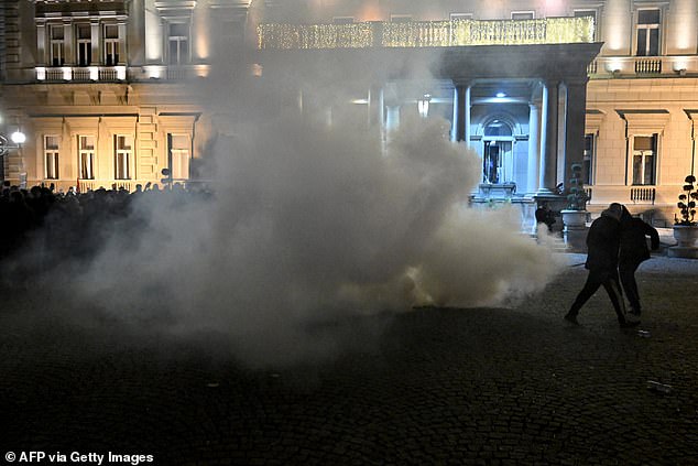 Riot police in Serbia fire tear gas to disperse protesters near Belgrade's town hall