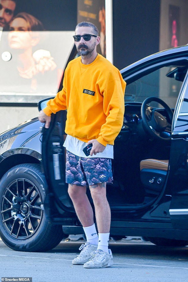 Shia LaBeouf, 37, cut a trendy figure in a bright orange sweatshirt Thursday as he headed out in his $54,000 dad van in Pasadena