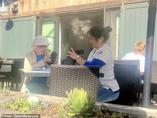 The actress opted for patio seating and stayed cool with a visor and large sunglasses, according to exclusive photos