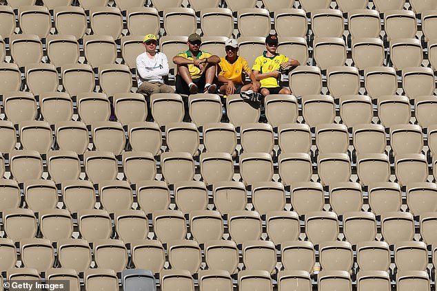 Four diehard supporters (pictured) showed how barren the Optus Stadium was during the first test against Pakistan in Perth