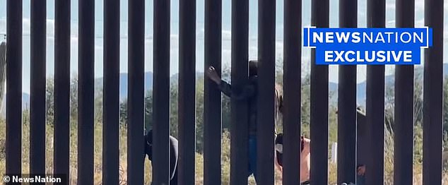 Human smugglers on the Arizona-Mexico border mock a news crew as they used power tools to blow a hole through the wall