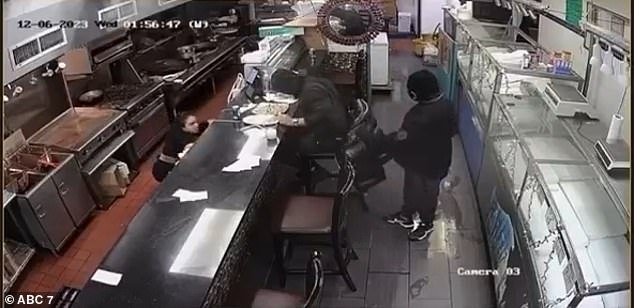 Surveillance footage captures the moment a masked armed robber shot a man in the face at a seafood restaurant