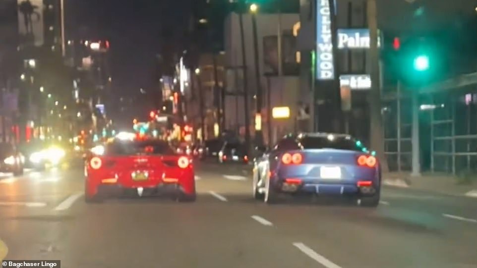 The video begins with two supercars driving side by side down Sunset Boulevard on December 2