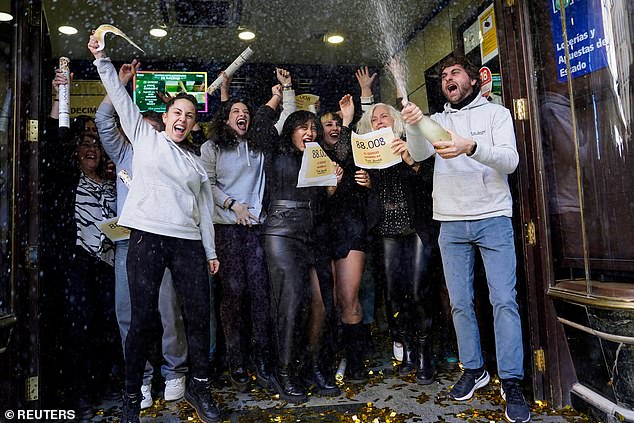 Holders of lottery tickets number 88008 are celebrating in Spain after winning the top prize in the huge Spanish Christmas lottery.  In the photo: Employees at Dona Manolita celebrate the sale of the first prize-winning ticket in the Spanish Christmas lottery "El Gordo"in Madrid, Spain, December 22