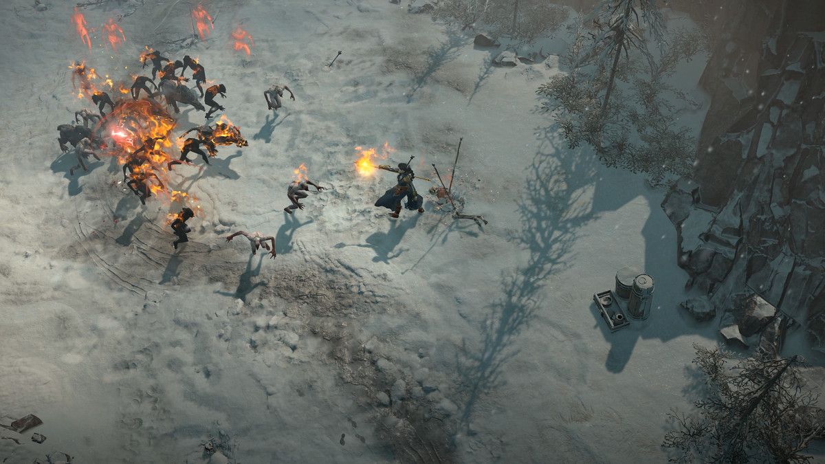 A player attacks enemies in a snowy tundra in Diablo 4 and uses powerful flame magic to fend off their foes.