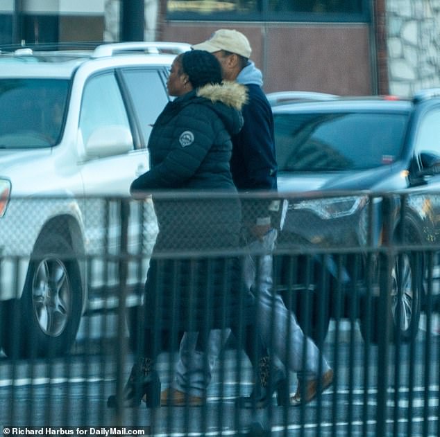 After leaving the court, she crossed the street and got into the passenger seat of a dark blue car