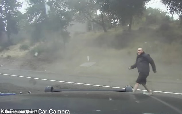 Zachary Wolffscott is seen moments after crashing his car into a grassy area on the shoulder of Interstate 80.  He held a knife in his right hand and happily skipped forward to stab the injured motorcyclist he hit.