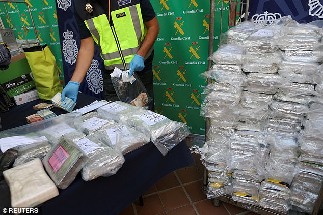 Police display some of the six tonnes of cocaine, cash and other materials seized during a drug bust on an industrial estate near police headquarters in Malaga, Spain