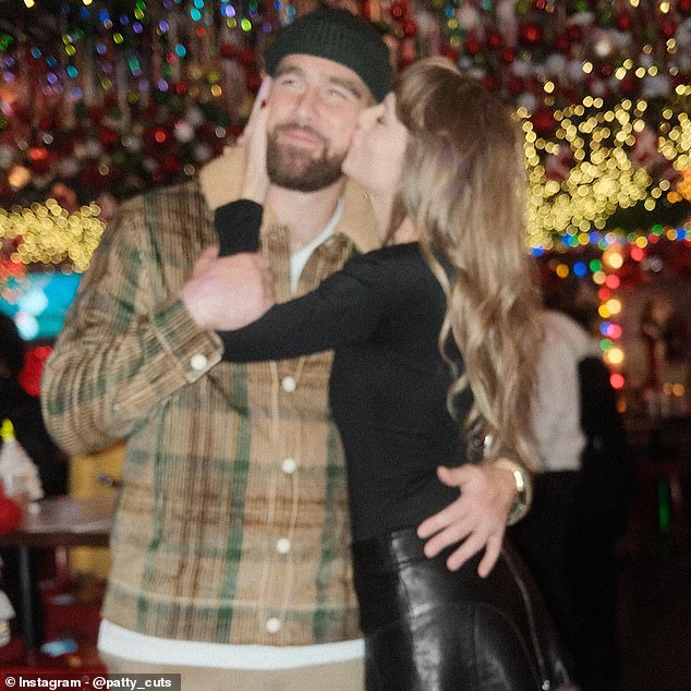 Taylor Swift plants a big kiss on the cheek of her boyfriend Travis Kelce on Sunday in Kansas City