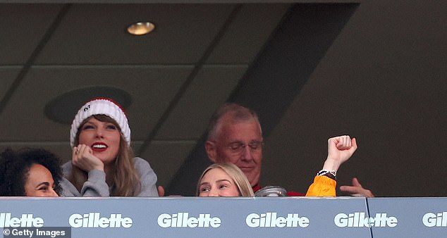 In addition to a gray sweatshirt supporting her friend's team, the Grammy winner also wore a white and red striped hat with a fluffy brown ball at the top and the number 87 stitched in black.