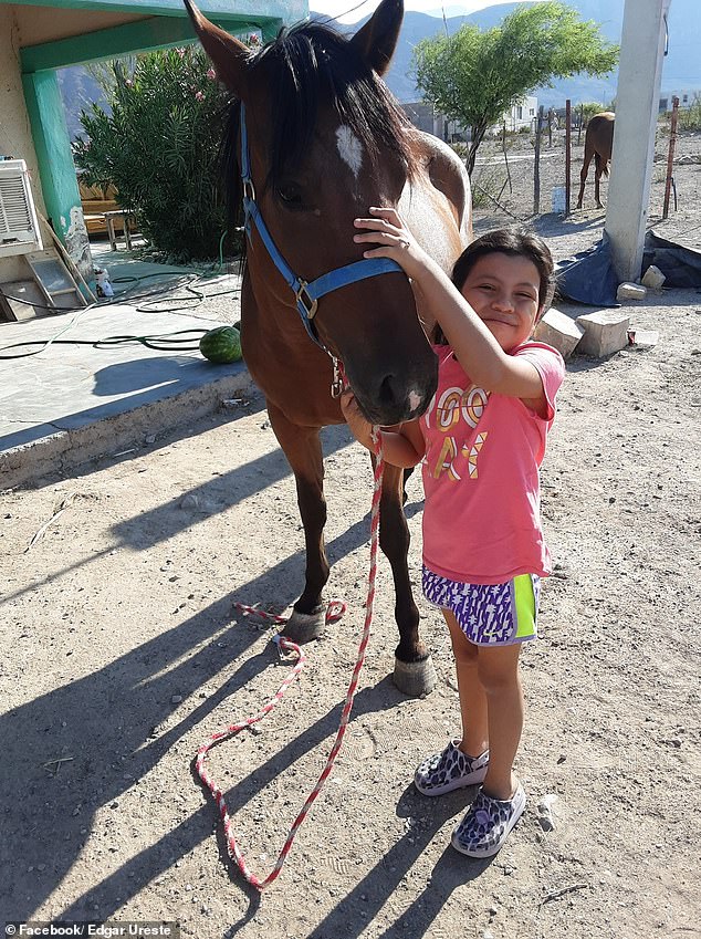 Edgar Ureste's daughter, Camila, 7, with her 'best friend' Corona after she returned