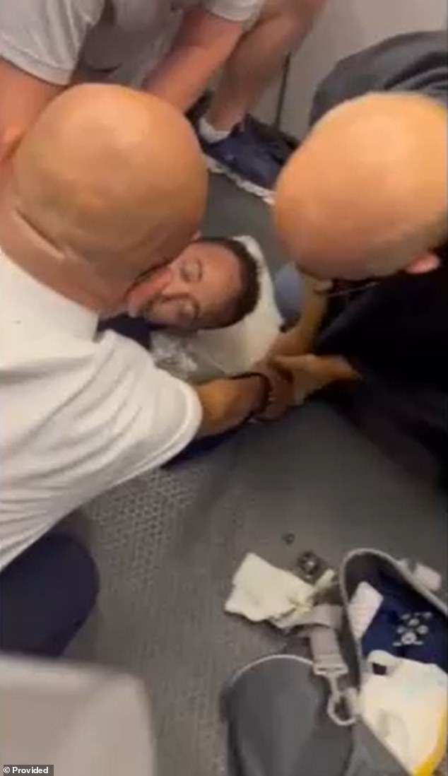 A Spanish-speaking American Airlines passenger was caught on camera being restrained by crew after having a meltdown before the flight could depart