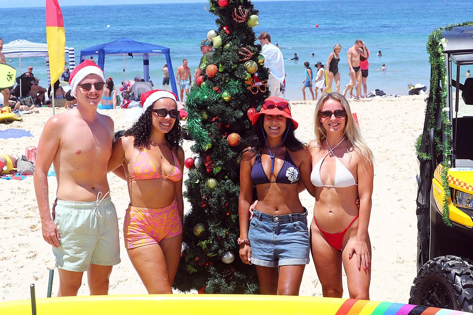 Beachgoers are seen on Bondi Beach on a beautiful sunny day