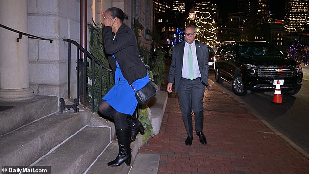 A woman covered her face as she arrived at the controversial party Wednesday night, before Suffolk County District Attorney Kevin Hayden