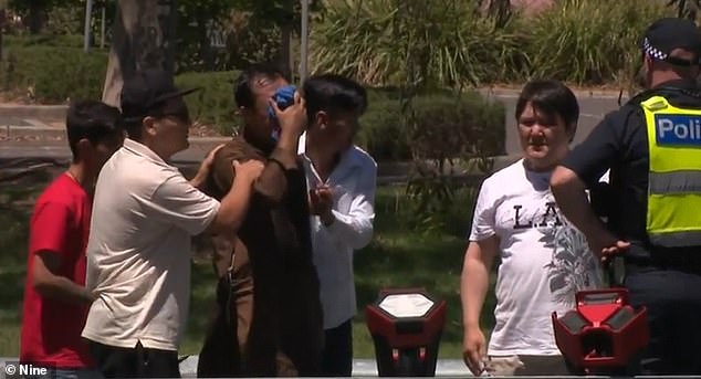 The boy was waiting with his father to cross the busy road.  The photo shows distraught family members at the scene