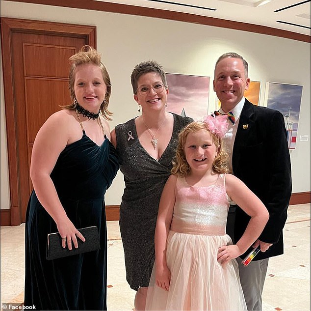 Astrid Burkle, 10, is seen with her sister Abs, mother Alicia and father Aaron